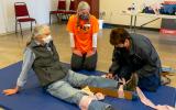 Participants practice splinting a leg.
