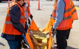 Participants carry a mannequin after extricating it during a search and rescue exercise.