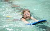 Kid swimming with board