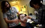 Volunteers at Majestic Theater putting make up on actors 