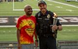 An officer and special olympics athlete pose with the ceremonial torch