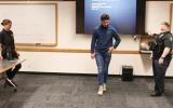A CPD101 class participant tests out "beer goggles" while two officers watch