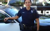 Cop standing in besides her car