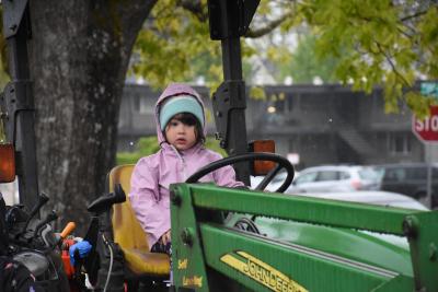 Girl on a green tractor.