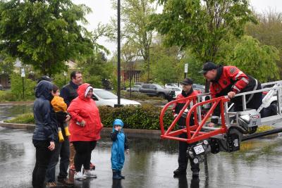 Family looking at a firetruck extension ladder. 