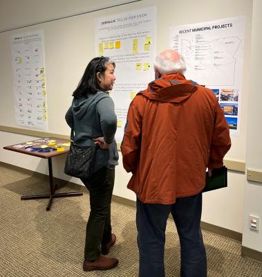 City Councilors review informational posters about the city facilities project