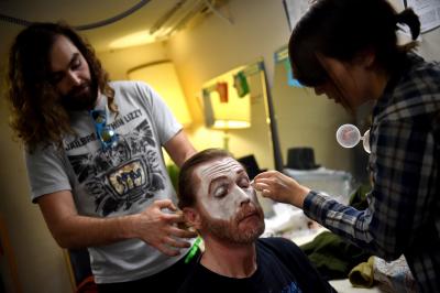 Volunteers at Majestic Theater putting make up on actors 