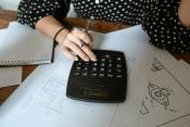 Woman using calculator