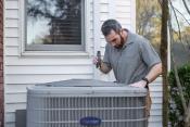 Man inspecting heat pump
