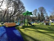 Park with play equipment and sunshine in background