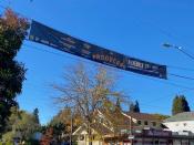 "Producers" banner hanging above stret with tree and building in background