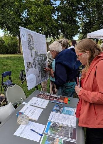 Neighbors join an outdoor ward meeting.