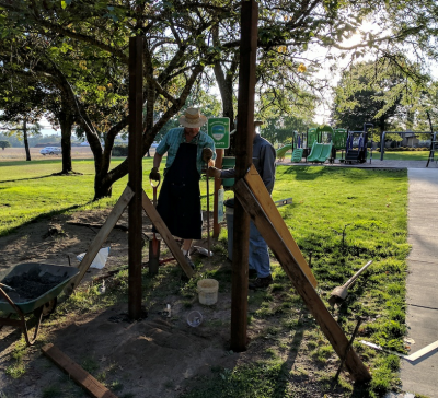 Arnold Park neighbors installing an announcement board in the neighborhood park.