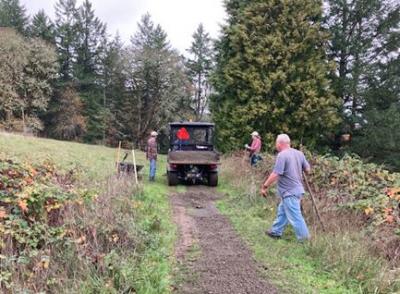 Neighbors spread gravel at Woodland Park.