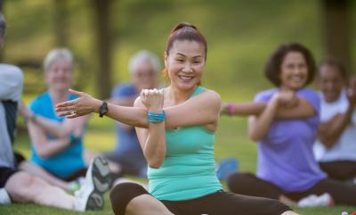 Group of people doing yoga outdoors.