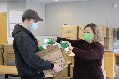 EDO staff handing out free masks and hand sanitizer to local businesses