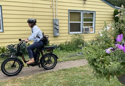E-bike pedaling past purple flowers