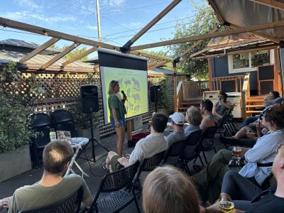 Image of a presentation with an audience. 