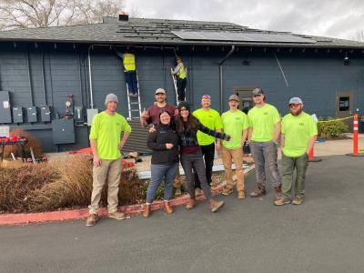 Construction workers in bright yellow shirts standing outside the Corvallis Community Center