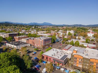 Downtown Corvallis Downtown Corvallis skyline with buildings and trees against a brilliant blue sky.