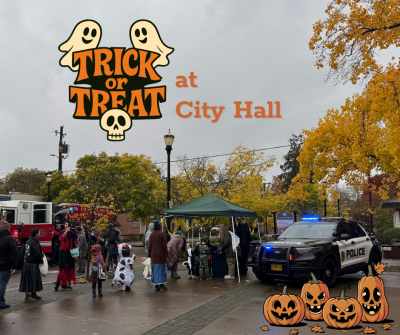 Trick or Treat Costumed trick or treaters visiting City Hall on a cloudy day. A tree with yellow leaves hangs over the outdoor plaza.