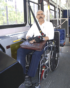 man riding the bus on a wheelchair