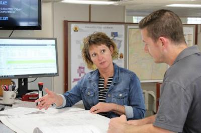 Permit Technician discussing plans 
