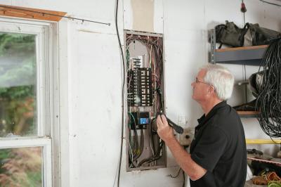 Man looking at electrical panel