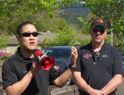 Corvallis and Benton County emergency managers speaking through a megaphone during an evacuation drill.
