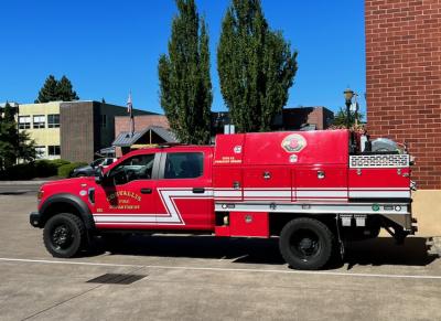 A red Type 6 fire engine built on a heavy duty pickup truck chassis, in service with the Corvallis Fire Department.