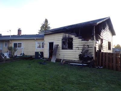 Single family home with burn marks on the garage.
