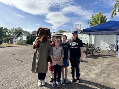 McGruff the crime fighting dog and a group of children outside at national night out