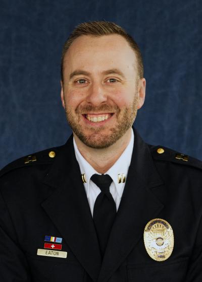 Image of Captain Ryan Eaton in a Class A police uniform smiling for a portrait