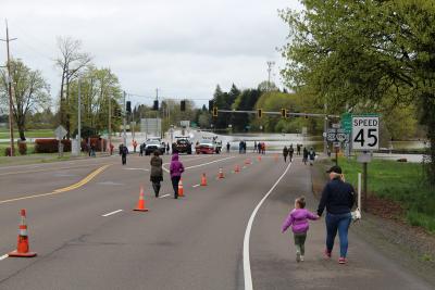 People looking at high water flowing over the highway just east of Corvallis