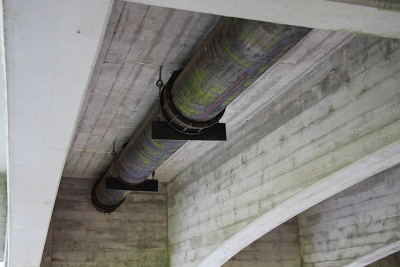 Existing metal water pipe running underneath the 4th Street bridge in Corvallis.