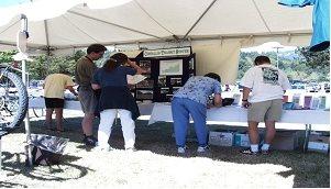 people standing at a booth