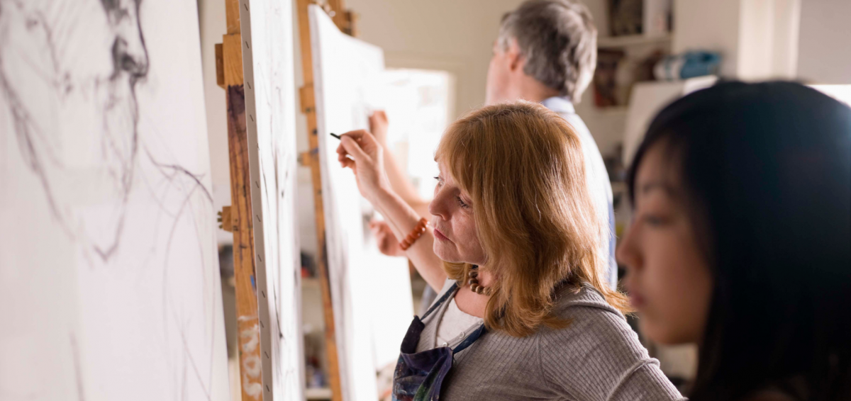 a woman sketching on a canvas