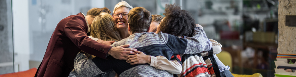 group hug of diverse individuals