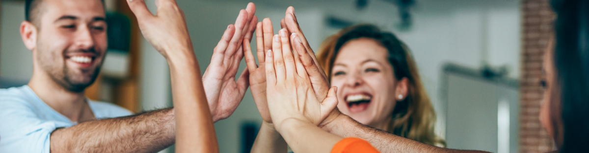 Group of adults high fiving each other