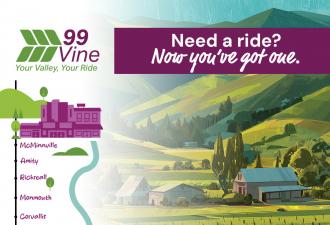 Transit bus driving through an idyllic valley road with green hillsides and sun shining.