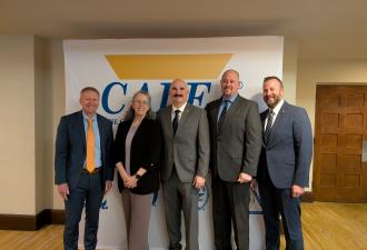 Agency Representatives In front of CALEA Sign