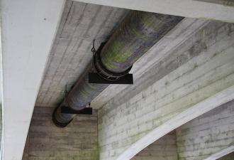 Existing metal water pipe running underneath the 4th Street bridge in Corvallis.