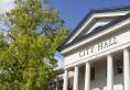 Corvallis City Hall with a green tree to the left, on a clear day with a sunny blue sky overhead.