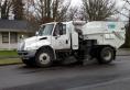 Street sweeper parked on the side of the road